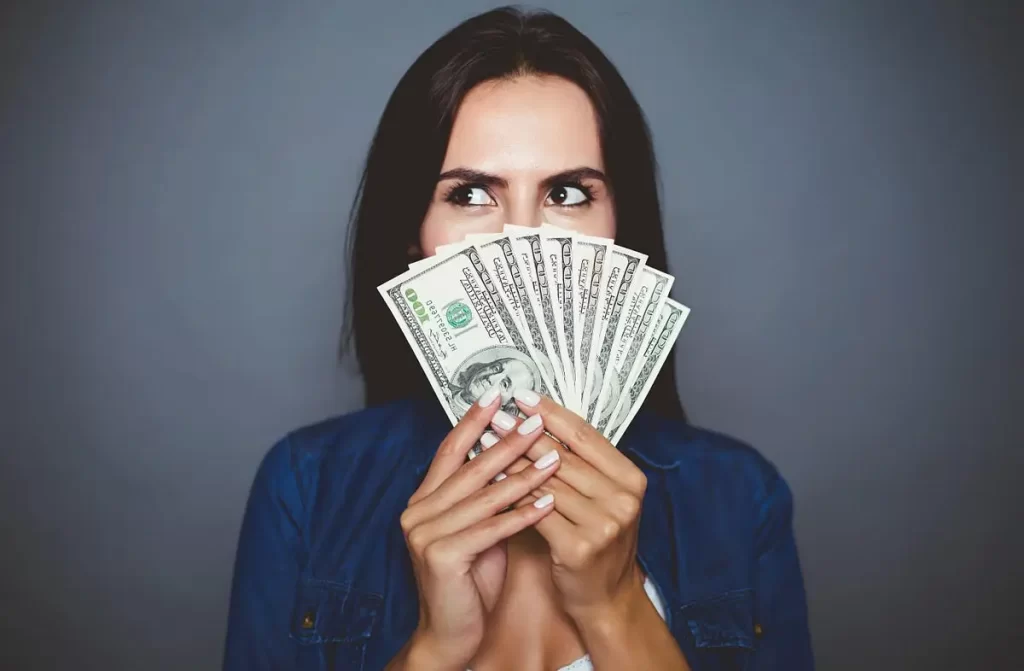 Woman Holding Money 1200px